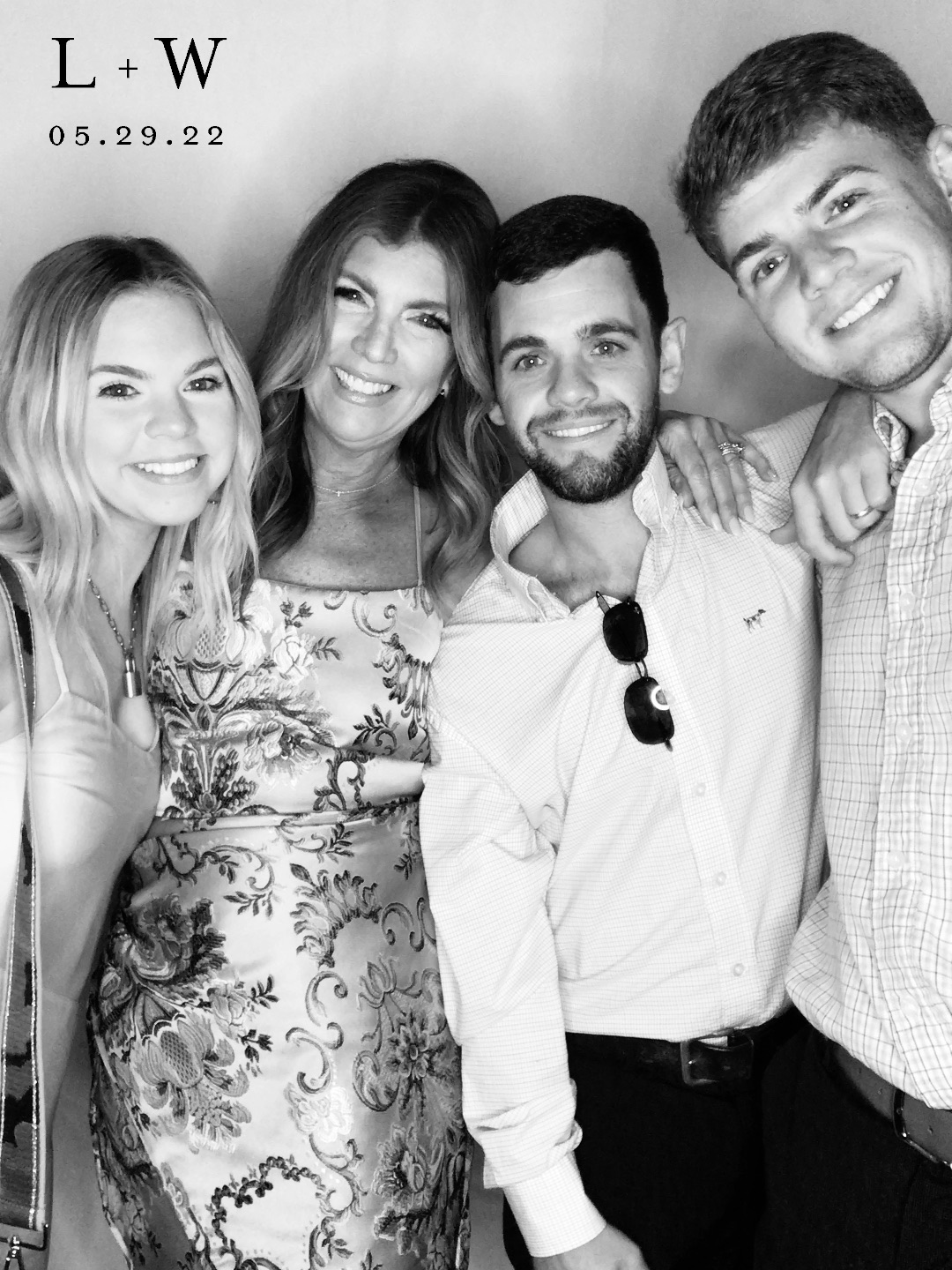 A group of smiling photo booth users in black and white